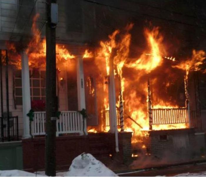 Fire coming out of the front of a house 