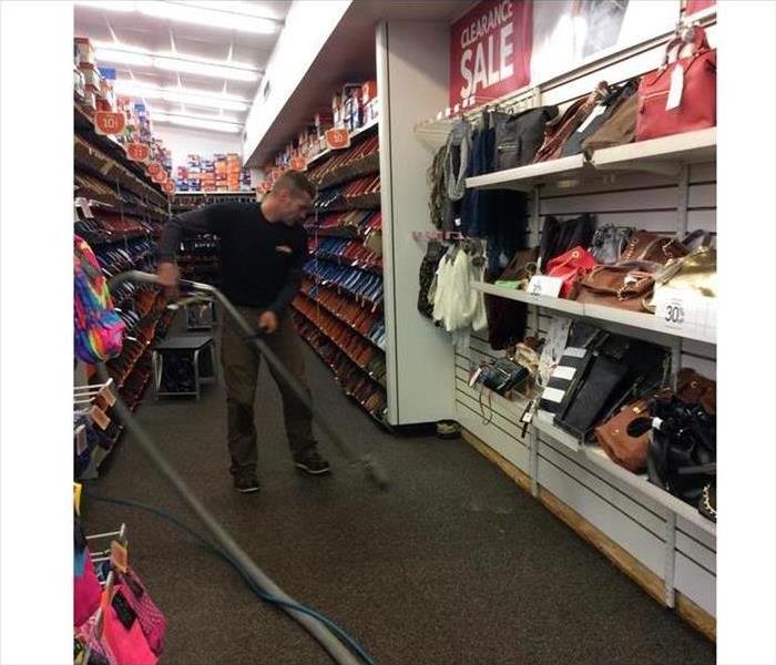 SERVPRO technician extracting water from retail store 