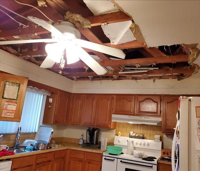 Kitchen with water damage in ceiling and cabinets 