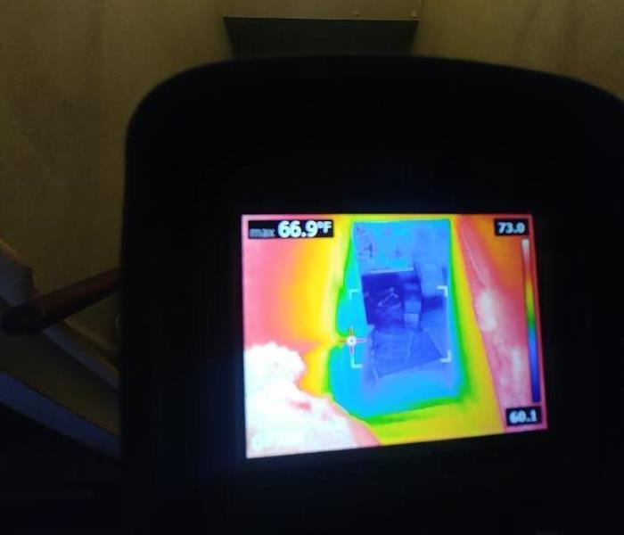 thermal camera looking down the same stair case showing its soaked 