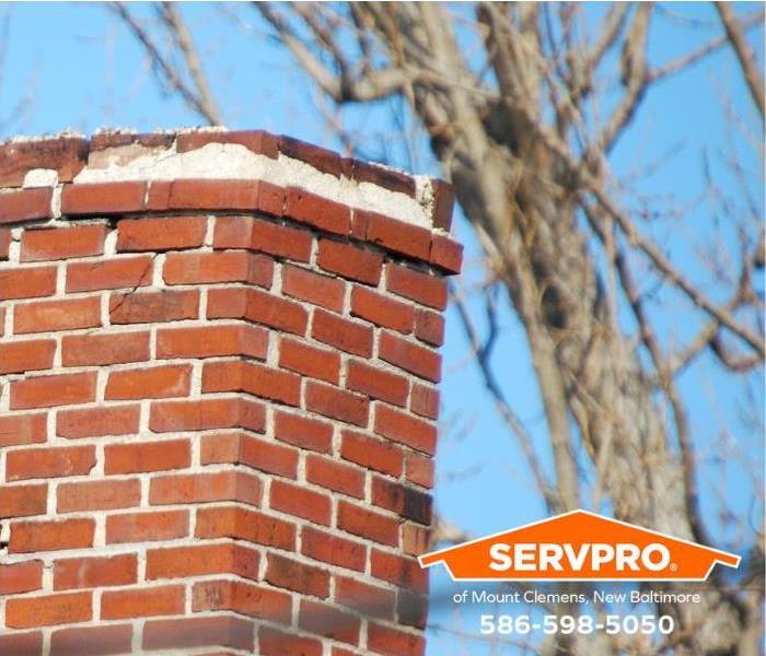 A chimney shows signs of cracks and disrepair.
