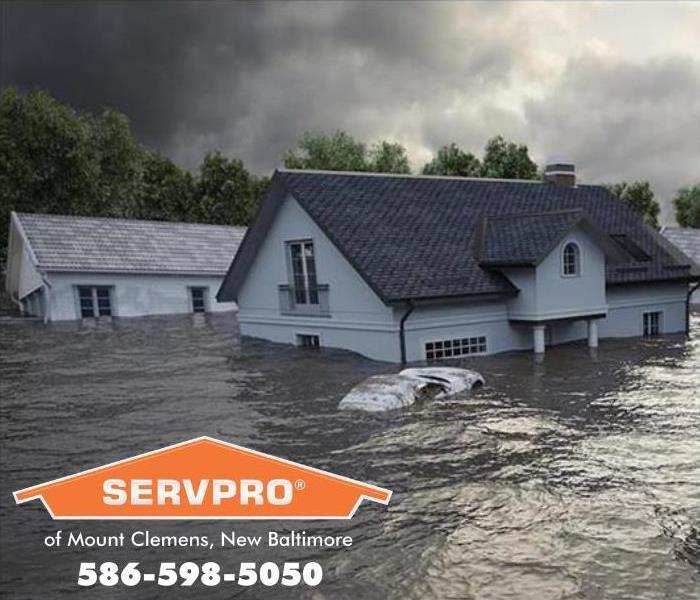 house in flood waters with SERVPRO logo