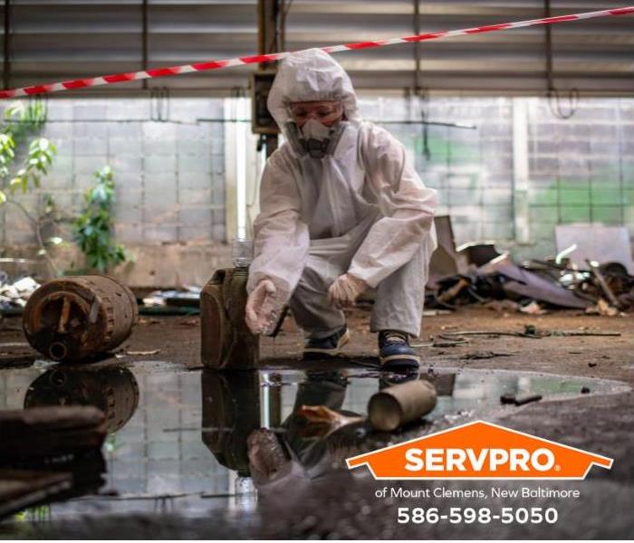 A technician begins the process of cleaning an area damaged by an oil spill.